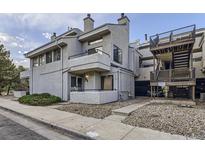 Charming condo exterior with a balcony and well maintained landscaping and stairs to other condos at 1830 Newland Ct # 209, Lakewood, CO 80214