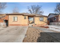 Charming brick home featuring a well-maintained front yard and inviting entrance at 2042 Jamaica St, Aurora, CO 80010