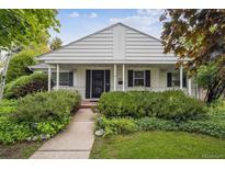 Inviting home with a covered porch and manicured landscaping, creating an appealing facade at 3201 S Albion St, Denver, CO 80222