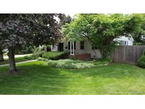 Charming home featuring a lush green lawn and mature trees in a serene front yard setting at 3201 S Albion St, Denver, CO 80222