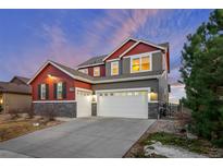 Charming two-story home featuring a three-car garage, stone accents, and appealing color palette at 17786 W 86Th Ln, Arvada, CO 80007