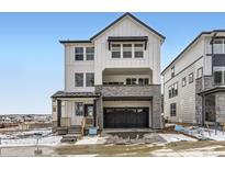 Charming two-story home with white siding, stone accents, and a covered front porch at 7157 Waterleaf Trl, Littleton, CO 80125