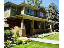 Charming two-story home with a well-manicured lawn and beautiful landscaping, offering great curb appeal at 1907 S Columbine St, Denver, CO 80210