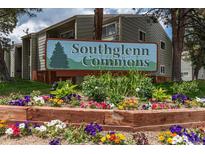 Southglenn Commons community sign, set among colorful flowers and lush greenery at 7275 S Gaylord St # I09, Littleton, CO 80122