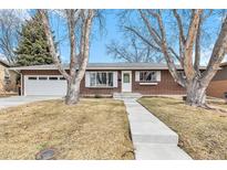 Charming brick home featuring a well-maintained lawn and inviting front entrance at 3276 S Osceola St, Denver, CO 80236