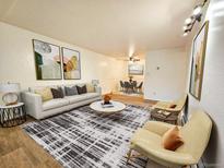 Bright living room with a modern sofa, stylish rug, and contemporary art at 1270 N Marion St # 103, Denver, CO 80218