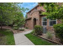 Stone exterior of townhome with landscaped walkway at 3512 Cascina Pl # A, Highlands Ranch, CO 80126