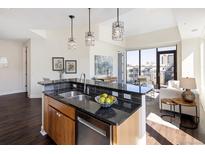Modern kitchen featuring granite countertops, stainless steel appliances, and island with pendant lighting at 1650 Fillmore St # 504, Denver, CO 80206