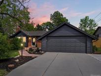 Charming home exterior with a well-manicured lawn and an attached two car garage at sunset at 3030 Alkire St, Golden, CO 80401