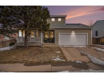 Two-story house with attached garage and landscaping at 7190 Pine Hills Way, Littleton, CO 80125