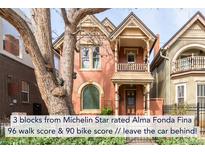 Charming two-story brick home with a covered front porch and balcony, showcasing its inviting facade at 3147 Vallejo St, Denver, CO 80211