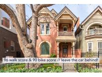 Charming two-story brick home featuring a quaint front porch and well-manicured lawn and garden at 3147 Vallejo St, Denver, CO 80211