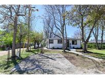 Charming single-story home with a gravel front yard, mature trees, and a welcoming walkway at 409 N Finch Ave, Lafayette, CO 80026