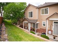 Charming townhome featuring a welcoming entrance and well-maintained landscaping at 6845 S Webster St # E, Littleton, CO 80128