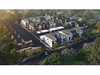Modern community with new construction homes, manicured landscaping, and tree-lined streets in aerial view at 621 Lombardi Cir, Louisville, CO 80027