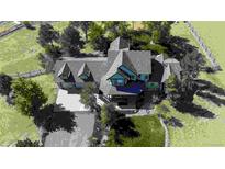 Aerial view of a beautiful home showcasing its roofline, mature landscaping, and a spacious driveway at 925 Antelope W Dr, Bennett, CO 80102