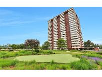 Stunning high-rise building featuring a well-manicured lawn, putting green, and lovely landscaping at 3131 E Alameda Ave # 704, Denver, CO 80209