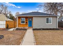 Charming single story home featuring two different siding styles and a bright blue front door at 2332 Hanover St, Aurora, CO 80010
