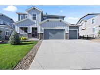 Beautiful two-story home with a three-car garage and landscaped front yard at 1665 Diamond Head Dr, Castle Rock, CO 80104
