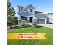 Charming two-story home with a well-manicured lawn and a welcoming front porch at 1665 Diamond Head Dr, Castle Rock, CO 80104