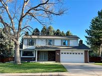 Charming two-story home with a well-manicured lawn, brick accents and an attached two car garage at 4640 W Princeton Ave, Denver, CO 80236