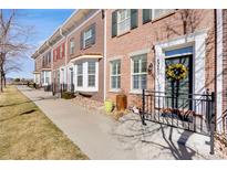 Charming brick townhome with landscaped front and inviting entry with floral wreath at 4357 W 118Th Pl, Westminster, CO 80031