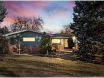 Ranch style home with brick and siding exterior, landscaping, and a two-car garage at 1750 Vance St, Lakewood, CO 80214