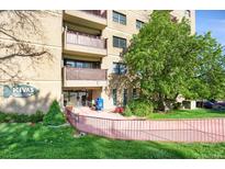 Condominium building with landscaping, walkway, and a view of balconies on a sunny day at 3675 S Cherokee St # 110, Englewood, CO 80110