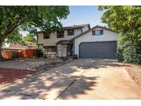 Charming two-story home featuring a two-car garage, landscaped front yard, and a welcoming entrance at 10851 E Iliff Pl, Aurora, CO 80014
