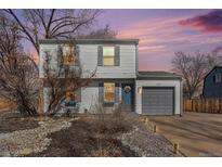 Charming two-story home with gray siding, a one-car garage, and xeriscaped front yard at dusk at 1277 W 135Th Pl, Broomfield, CO 80234