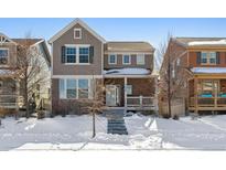 Two-story house with brick and siding exterior, steps leading to covered porch at 21646 E Stroll Ave, Parker, CO 80138