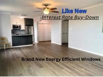 Open-concept living space with modern kitchen, hardwood floors, new windows and ceiling fan at 320 S Ames St # 5, Lakewood, CO 80226