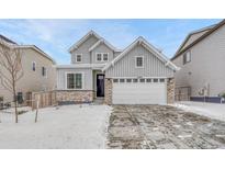 Charming two-story home with a two-car garage and appealing gray exterior at 13353 Amber Sky St, Parker, CO 80134