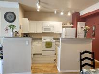 Bright kitchen features white appliances, ample cabinetry, and granite countertops, offering a functional cooking space at 1659 Harris St, Superior, CO 80027