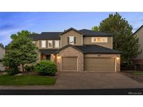 Charming two-story home boasts a two-car garage, manicured lawn, and brick accents at 10524 Serengeti Dr, Lone Tree, CO 80124