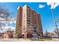 Brick apartment building featuring multiple stories, balconies, and convenient access to public transportation at 1301 Speer Blvd # 309, Denver, CO 80204