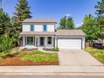 Charming two-story home with white exterior, trimmed windows and front two-car garage at 655 Gooseberry Ct, Lafayette, CO 80026