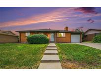 Charming brick home with a well-maintained front yard and inviting walkway at 2280 Sherrelwood Dr, Denver, CO 80221