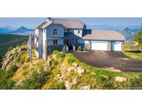 Stunning hillside home with stone accents, three car garage, and mountain views at 14440 Eagle Vista Dr, Littleton, CO 80127