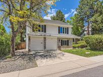 Charming two-story home featuring a two-car garage, brick accents, and mature trees in a suburban neighborhood at 6379 S Jasmine Way, Centennial, CO 80111