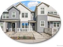 Charming townhome with gray siding, white accents, and inviting front porch area at 2059 S Vance Way, Denver, CO 80227