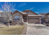 Charming home with stone accents, a two-car garage, and a well-maintained front yard at 12732 Fisher Dr, Englewood, CO 80112