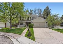 Charming two-story home with a well-manicured lawn and a welcoming front porch at 6432 E Jamison Cir, Centennial, CO 80112