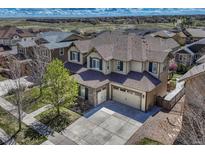 Beautiful two-story home featuring a two-car garage, well-manicured lawn, and lovely landscaping at 26566 E Peakview Dr, Aurora, CO 80016