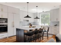 Bright kitchen with a large island, modern appliances, and stylish pendant lighting at 3130 Wyandot St, Denver, CO 80211