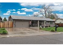 Charming single-story home with inviting curb appeal, landscaped front yard, and a two-car garage at 8151 S Marshall Ct, Littleton, CO 80128