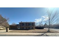 Charming two-story home featuring a well-maintained front yard and attached garage at 1592 S Memphis St, Aurora, CO 80017