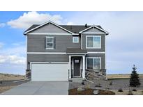 Two-story home with gray siding and a white garage door at 43074 Merion Hills Ct, Elizabeth, CO 80107