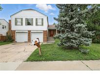 Charming two-story home featuring a two-car garage, brick accents, and mature landscaping at 2527 S Ouray Way, Aurora, CO 80013