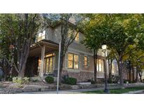 Charming home with stone accents and ample natural light streaming through the shuttered windows at 203 S Jackson St, Denver, CO 80209